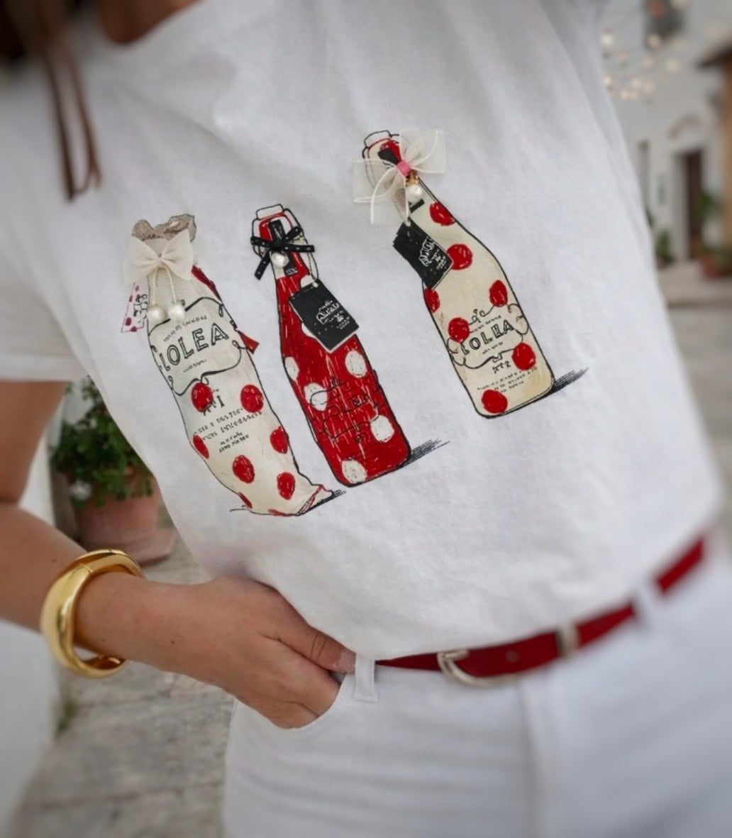 Primer plano de camiseta Botellas Lolea con detalles de perlitas y lacitos
